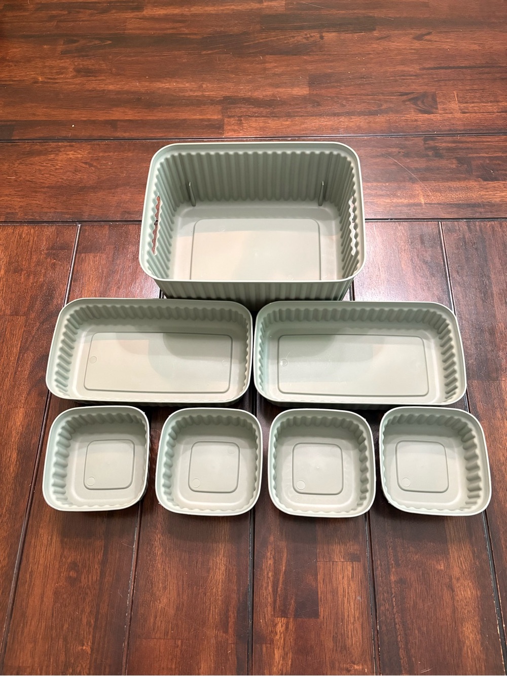 Set of 7 sage green plastic storage containers